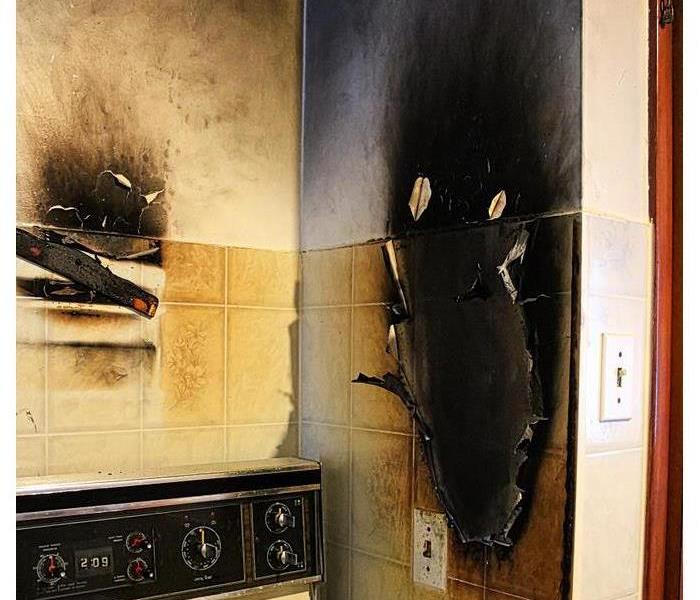 a kitchen with charred walls near the oven